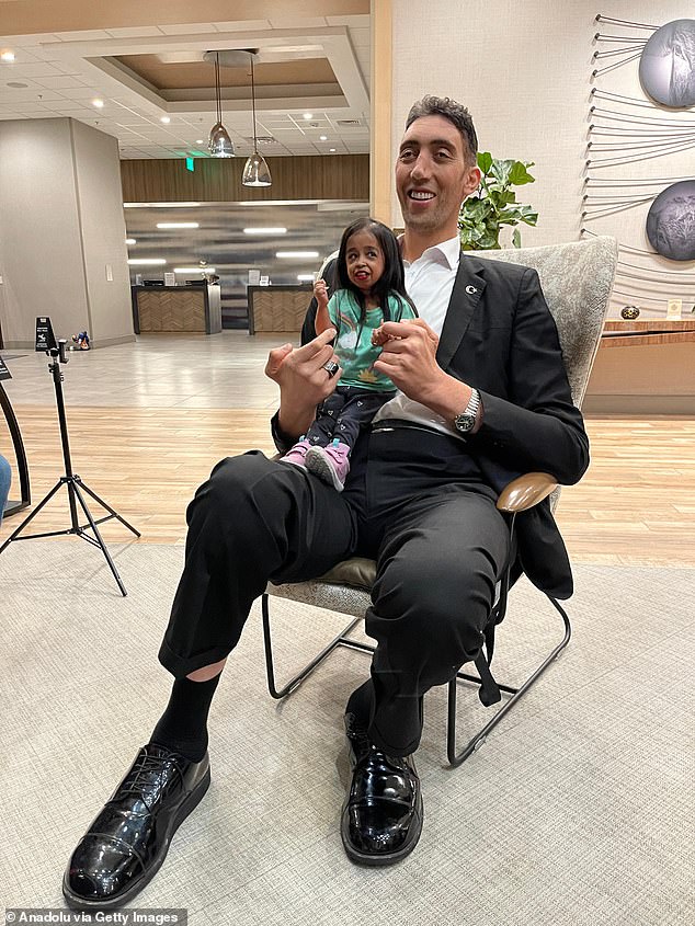 Sultan Kosen, who is 8 feet 3 inches tall, and Jyoti Amge, who is just 2 feet tall, were a striking couple as they posed for photos in Irvine, California, yesterday.