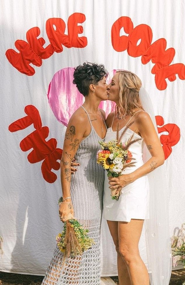 Ellen exchanged vows with her groom, sealing their union with a kiss in front of a charming handmade celebration banner that read 