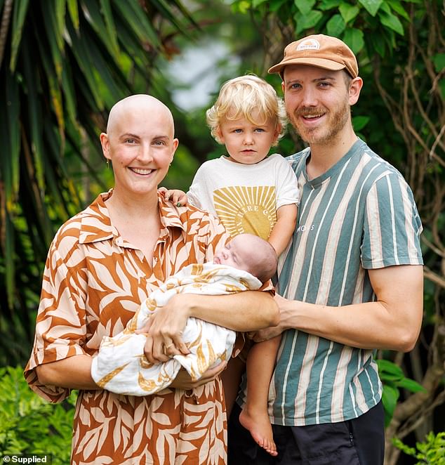 Emily Wiles (left) is battling ovarian cancer after a 5kg tumor was discovered in her abdomen when she was 33 weeks pregnant with her son Eli (centre left).  Pictured is her with her oldest son Asa (center right) and her husband Luke (right)