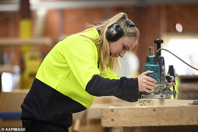 Women could be encouraged to take up an apprenticeship as Australia battles a serious shortage of construction professionals (pictured, Melbourne staircase maker Paige Hunter).