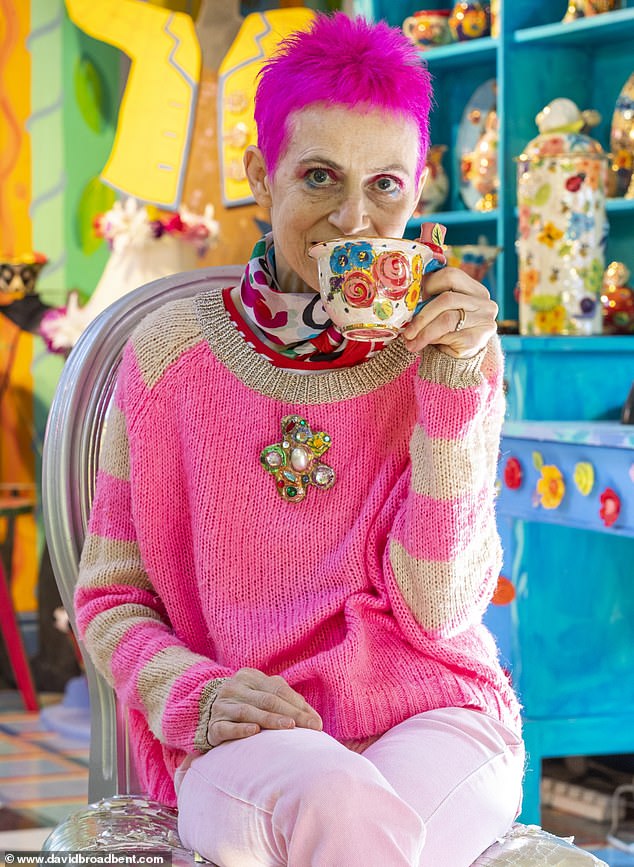 Pictured: Artist Mary Rose Young having a cup of tea in her home ceramics studio, which features a multi-coloured ceiling.