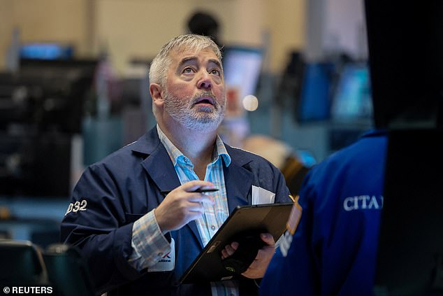 The S&P 500 hit an all-time high of 5,000 on Thursday.  In the photo, a trader at the New York Stock Exchange dribbling a basketball.