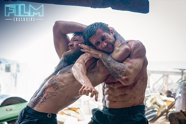 Jake Gyllenhaal showed off his ripped physique while battling Conor McGregor in new footage from his 1980s remake of Road House.