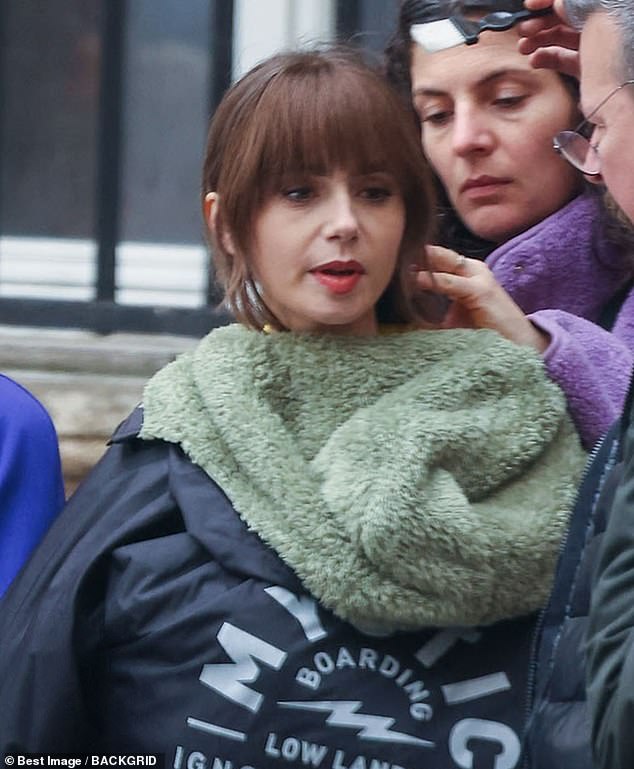 Lily Collins, 34, tried to stay warm while filming Emily in Paris on Friday