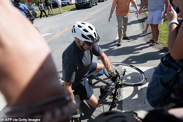 Joe Biden photographed falling off his bicycle during a ride near his Rehoboth Beach home in Delaware in June 2022, as he and his wife celebrated their 45th wedding anniversary.