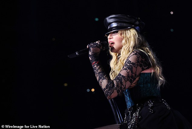 Madonna, 65, recovered quickly after suffering a spill on stage in Seattle during her Celebration tour over the weekend after a dancer dragging her in a chair slipped and both ended up with their feet in the air. (pictured in London in October 2023).