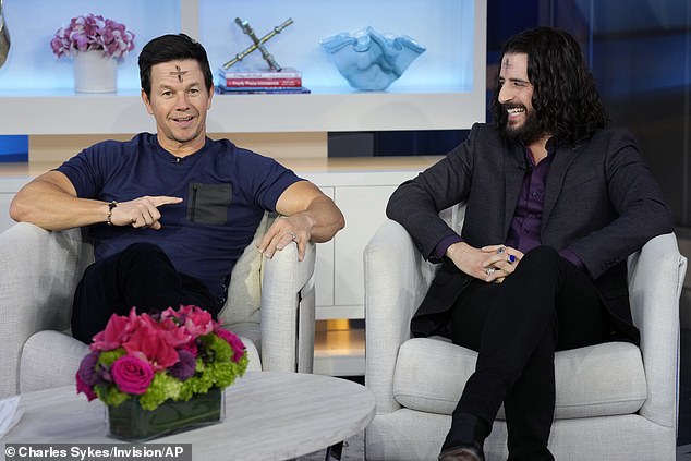 Mark Wahlberg and Jonathan Roumie wear their Ash Wednesday brands during an appearance on Fox & Friends to promote their Hallow prayer app.