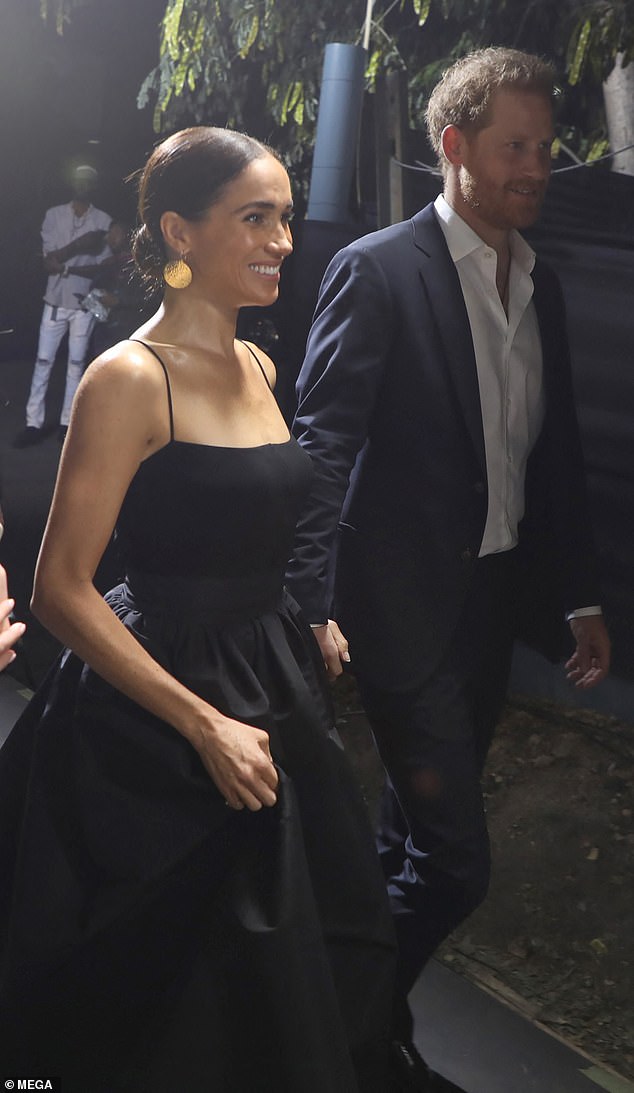 The Duchess of Sussex, 42, oozed glamor in the monochrome ensemble, which she paired with a simple suit, on Tuesday night.