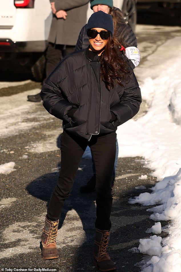 Meghan Markle looked stylish and cozy as she watched Prince Harry launch down a toboggan run in Whistler, Canada.