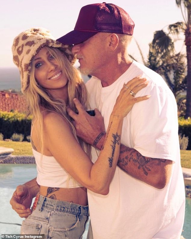Miley Cyrus' mother Tish claims she has never been happier since splitting from her ex Billy Ray Cyrus, whom she met in a club when she was just 24;  seen with her new husband Dominic Purcell