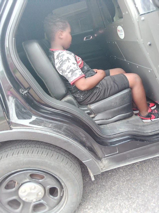 Quantavious Eason, 10, was arrested in August by the Senatobia Police Department for urinating in public.  He appears in the photo in the back of the police vehicle.