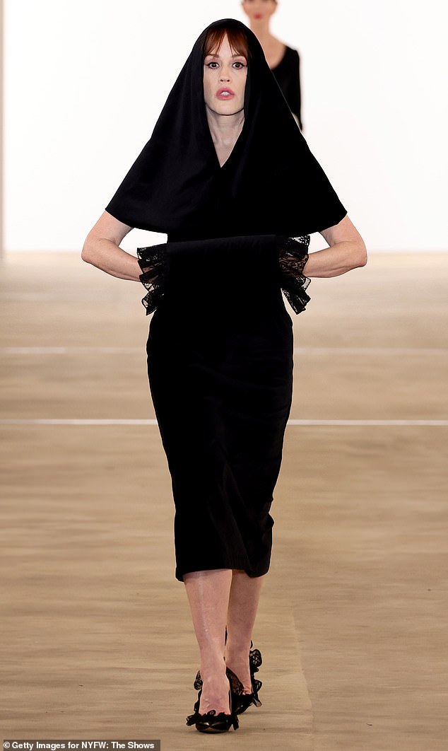 She also modeled a second look, a more modern black dress with a lace cuff and veil.