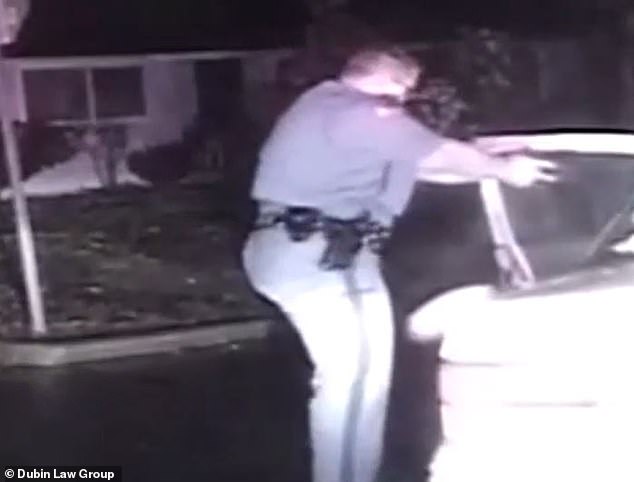 Moment Washington cop runs up to car with gun drawn to arrest a woman suffering a life-threatening stroke thinking she was an intoxicated driver