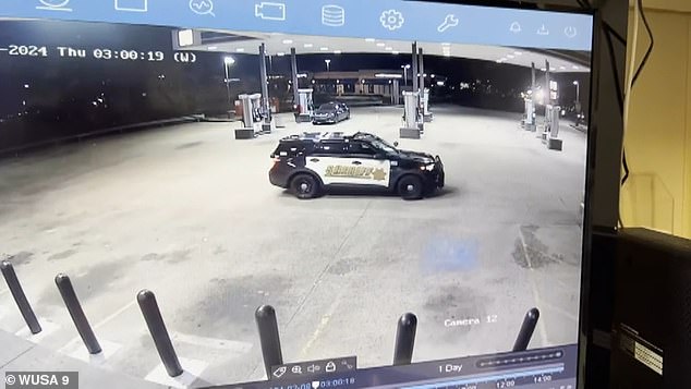 This is the shocking moment three robbery suspects run out of a gas station and jump into a getaway car parked two feet in front of a police car as the useless cop panics.