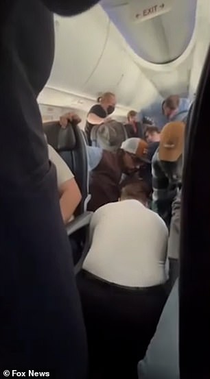 An American Airlines crew member was seen on video using duct tape to restrain the unnamed man's legs, as well as flexible handcuffs for his hands.