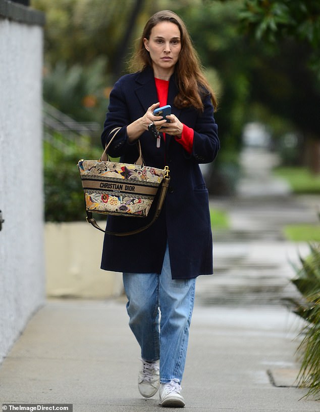 Natalie Portman was spotted out for dinner in Los Angeles on Monday.  The Black Swan actress, 42, wore a long blue coat and jeans paired with a trendy Christian Dior bag.  She left the ring amid rumors of a split with her husband Benjamin Millepied.