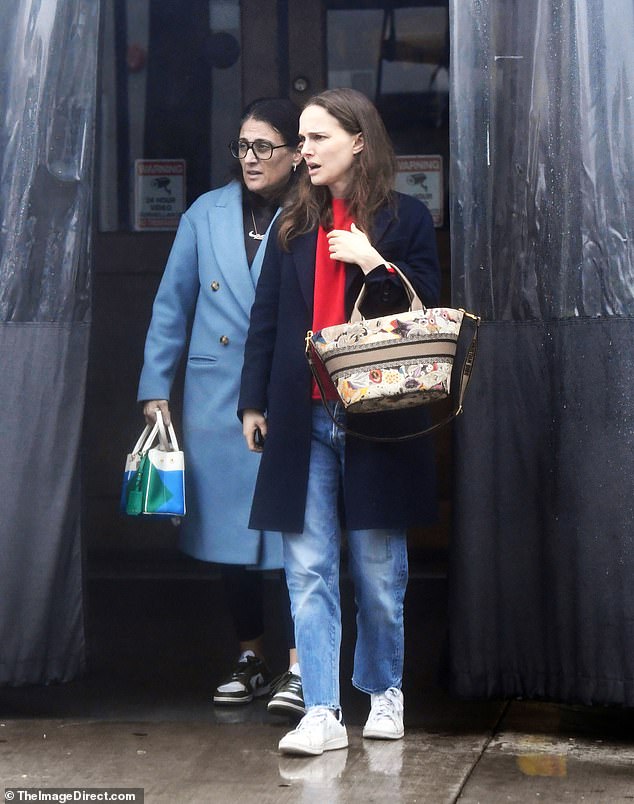 She was also seen with a friend.  The star wore no makeup with her hair down as she checked her cell phone.