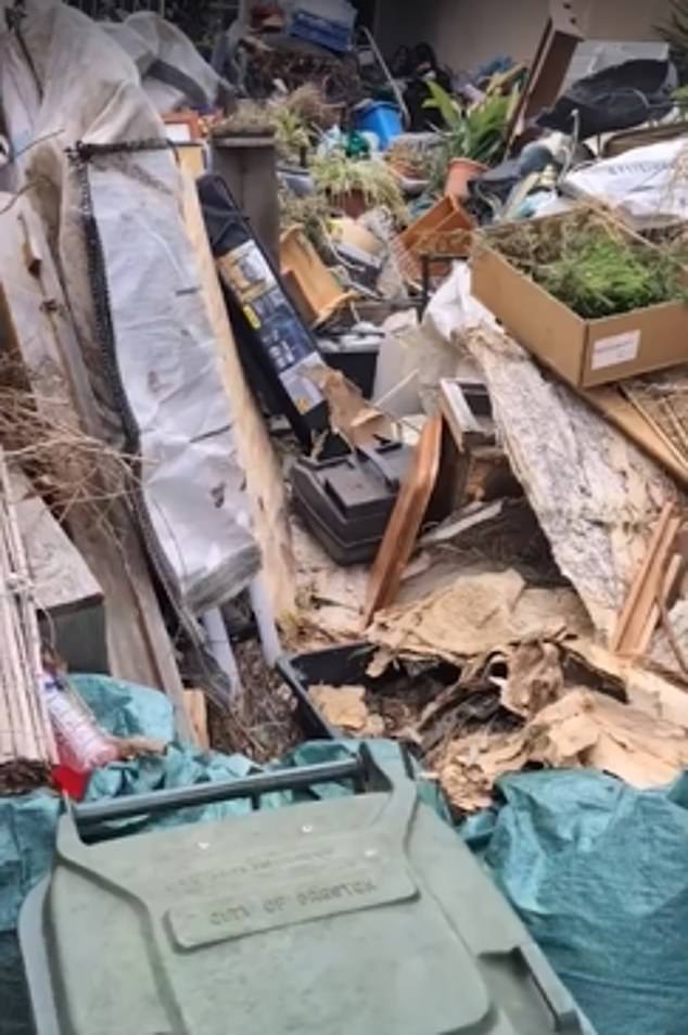 A Melbourne woman shared photos of her neighbour's garden (pictured) after reaching her wits' end with the huge pile of rubbish.