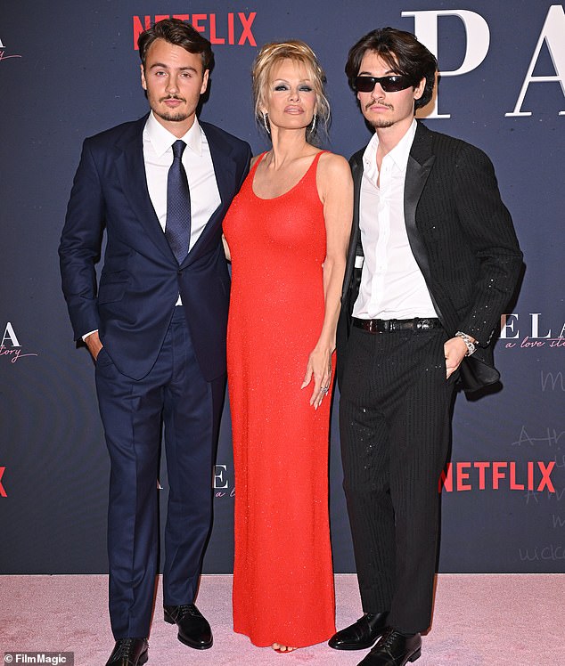 Pamela sports a heavily made-up face with her two sons, Brandon Thomas, 27, and Dylan Jagger, 26, from her marriage to Tommy Lee, 61, (pictured together in January).