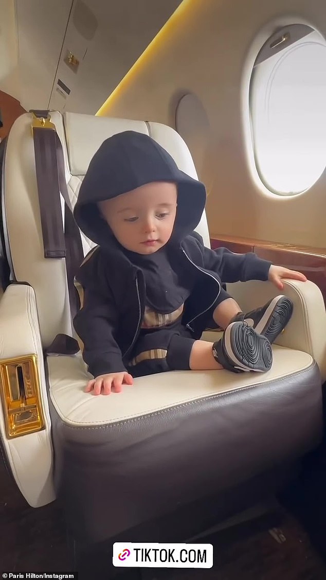 Their little one wore a Burberry ensemble while sitting on the private plane.