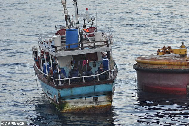 Asylum seekers attempting to disembark in Australia by boat has been an explosive topic in recent political history (pictured, a boat of asylum seekers in 2012 is escorted to Christmas Island by navy personnel).