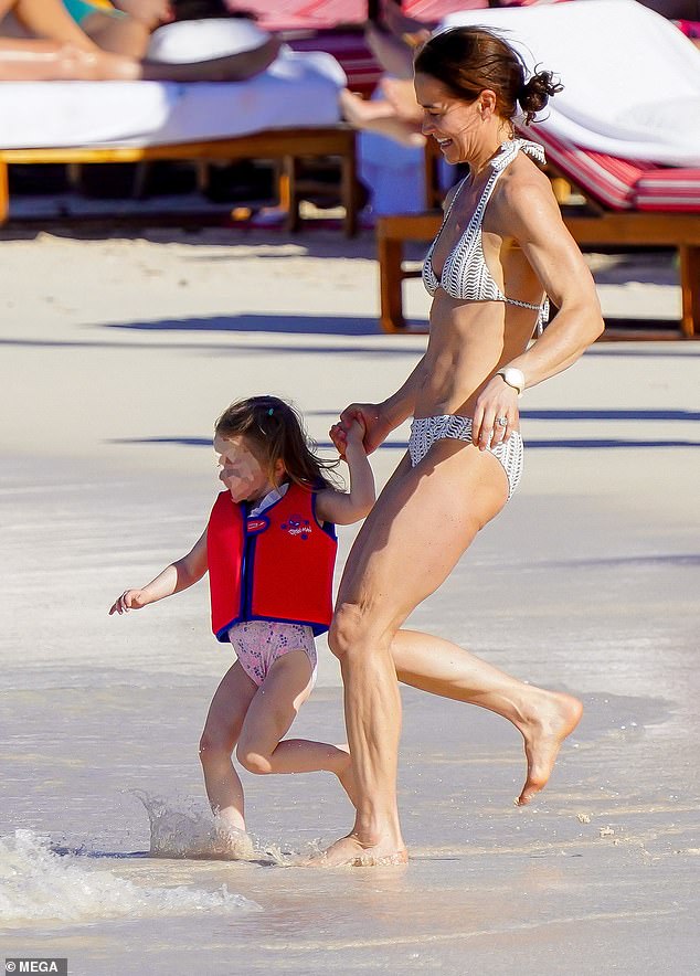 Pictured: Pippa Middleton seen running into the water with her eldest daughter Grace earlier this month.