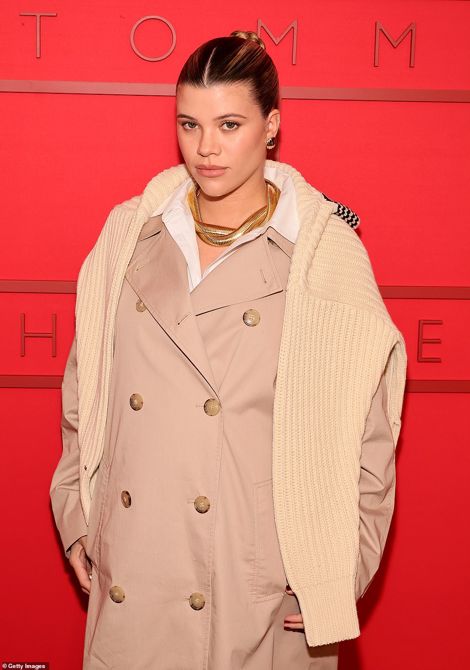 The brand's new ambassador, Sofia, 25, cradled her baby bump in a chic tan trench coat.