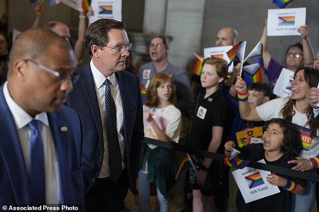 The Republican-led Tennessee House of Representatives passed a bill that would ban the display of gay pride flags in school classrooms.  House Speaker Cameron Sexton walks alongside protesters.