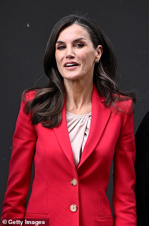 Letizia added a pleated blouse and delicate gold earrings