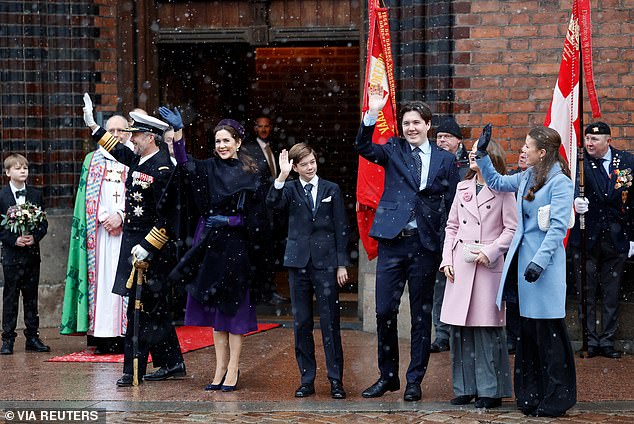 King Frederick X, Queen Mary and their children, Prince Vincent, Crown Prince Christian, Princess Elizabeth and Princess Josephine greet supporters at Aarhus Cathedral.