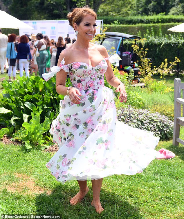 In July, Zarin hosted her annual exclusive luncheon in Southampton while smiling brightly in a long white, pastel pink and green floral dress.