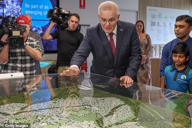 Scott Morrison's plan to allow Australians to invest $50,000 of their surplus into the purchase of their first home could help them get into the market much sooner as prices rise (the Prime Minister is pictured campaigning in Ipswich on Monday).