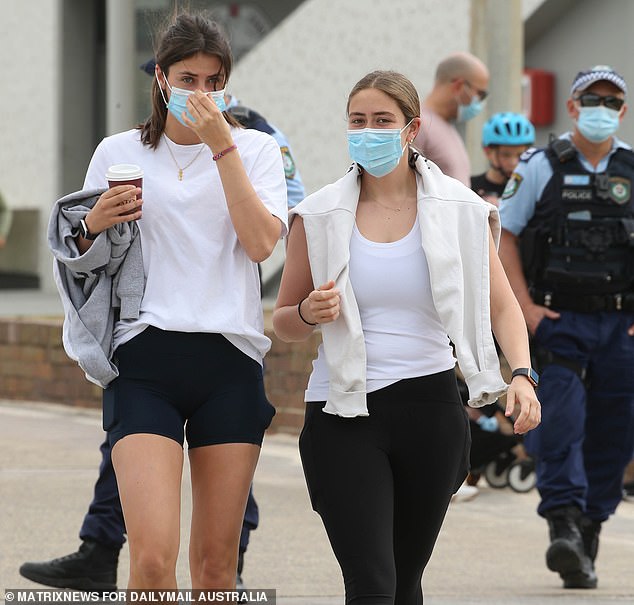 Pictured: Police monitor people walking on Bondi Beach during Sydney's lockdown in August 2021.