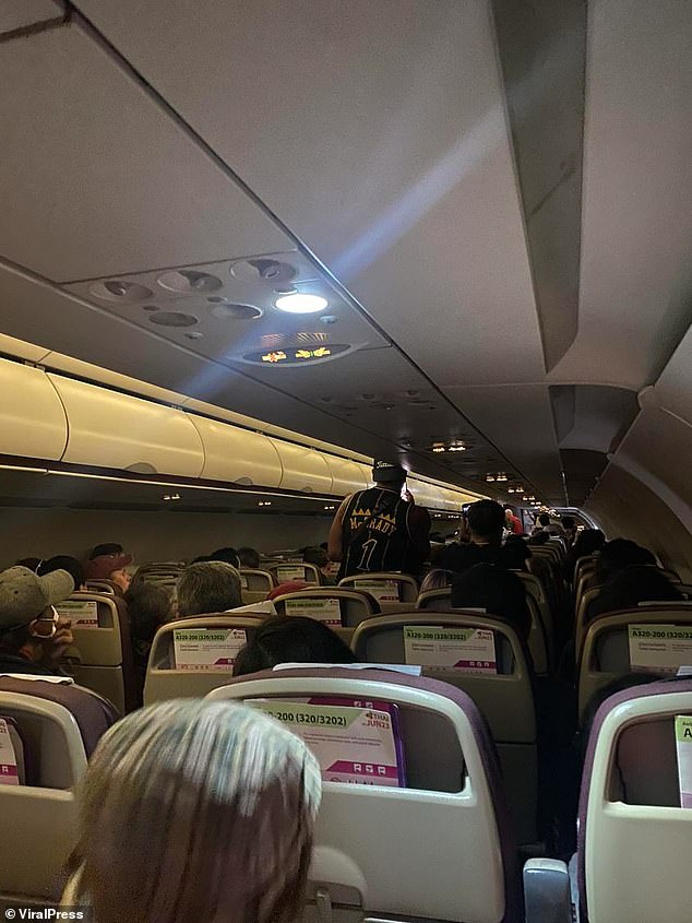 Passengers on the plane. Heung caused alarm when he suddenly screamed, left his seat and demanded the flight attendants open the plane door.