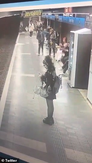 The man can be seen walking across the platform and lunging at different women before knocking one to the ground.