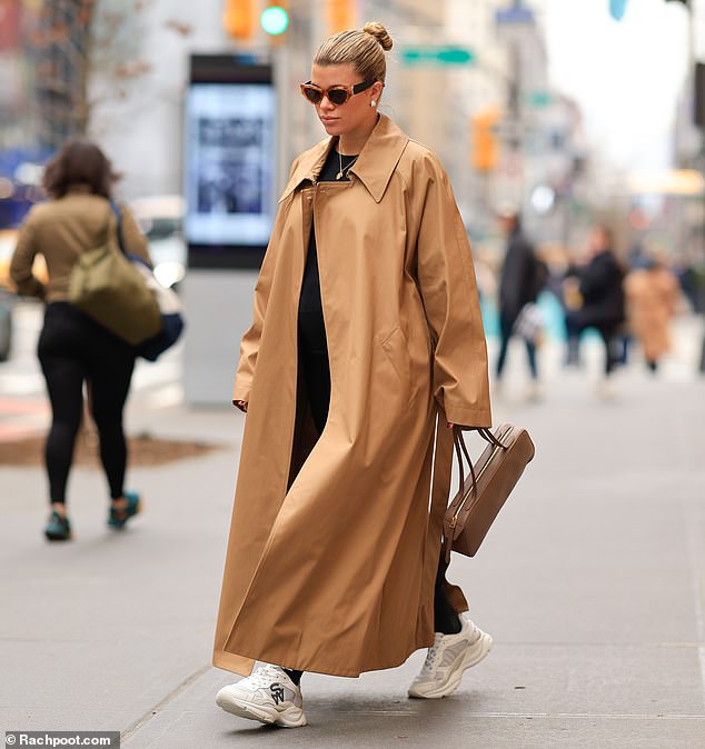 Sofia Richie, 25, looked chic as she stepped out in New York on Saturday.  The model, who is expecting her first child with her husband Elliot Grainge, 30, wore a long tan coat that camouflaged her growing baby bump.