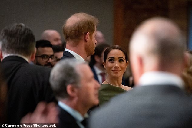 Meghan looked glamorous in an olive green one-shoulder dress by Canadian designer Greta Constantine, as well as a Logan Hollowell necklace and Manolo Blahnik shoes.
