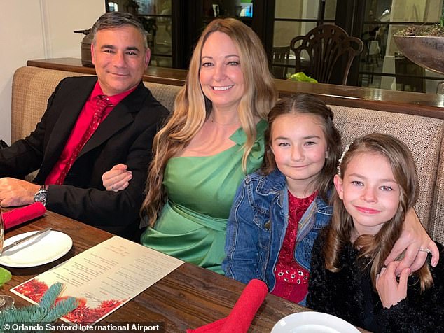 Orlando Sanford Airport Police Officer Andrew Tedesco is suing a Florida school board after his wife, Nicole, died after being struck by lightning.  They appear in the photo with his two daughters, Ava, 10, and Gia, 8.