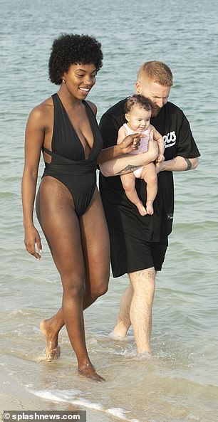 The former Love Island star, 25, who welcomed her daughter with Neil, 41, in October, showed off her incredible figure in a low-cut black swimsuit.
