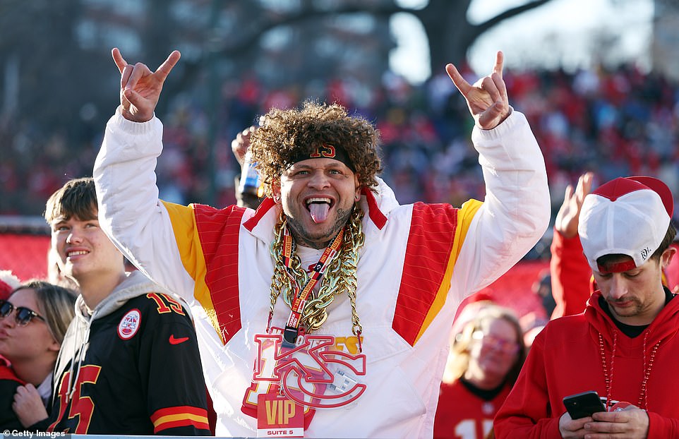 Chiefs fan Scott Shepard poses with 'KC' chains around his neck before the parade, where 1 million fans are expected to attend.