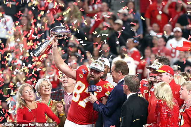 Taylor Swift holds back tears and grips Donna Kelce’s hand as Travis sings ‘Viva Las Vegas’ to the crowd and lifts the Super Bowl trophy – before vowing that the Kansas City Chiefs will ‘see you next year’ for the three-peat