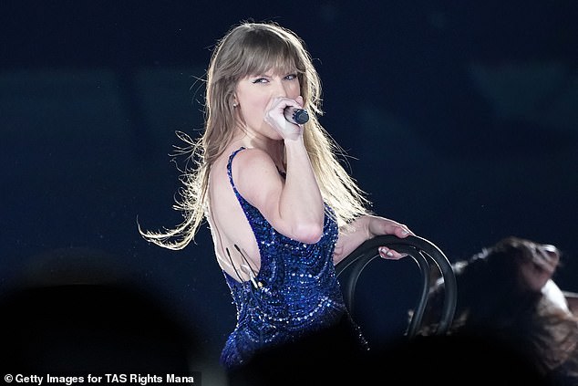 Taylor nearly fell off her chair during a passionate performance on her The Eras Tour in Tokyo on Wednesday (pictured performing)