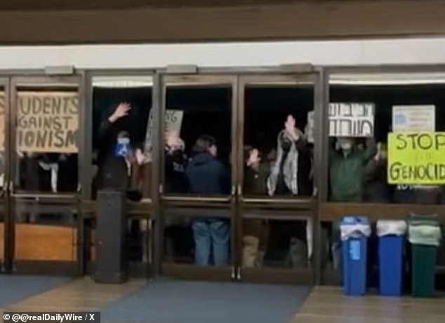 Video footage captured the moment a large crowd is seen banging on the glass doors of the University of California-Berkeley theater after an IDF soldier was invited to speak.