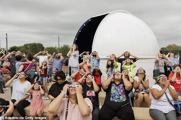 With thousands of visitors flocking to Texas cities to see this rare phenomenon, authorities anticipate strains on the supply of food, groceries and fuel, along with local infrastructure. Pictured: People watch the annular solar eclipse in Brownsville, Texas.