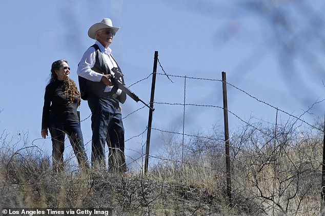 Jim Chilton, pictured with his wife Sue, holds a rifle with a telescopic sight as he surveys the land of his ranch in Arizona, which has become a corridor for thousands of immigrants entering the United States illegally.
