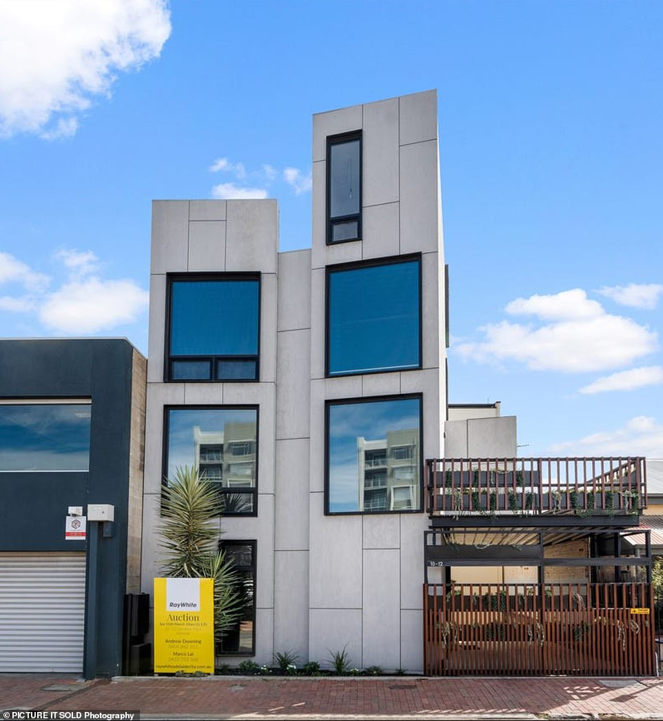 A striking four-storey home made up of eight stacked shipping containers with a unique bathtub, a sunny roof terrace and a striking angular façade is located on Adelaide's smallest residential block.