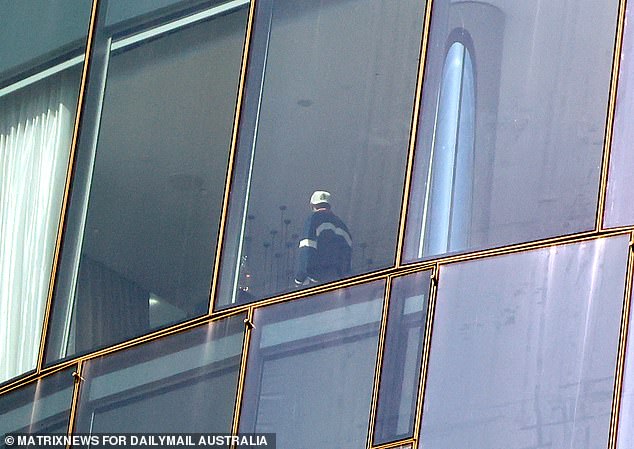 Ross, 31, who is also a tight end, kept it casual in a white cap and oversized football jersey as he stood by the window.