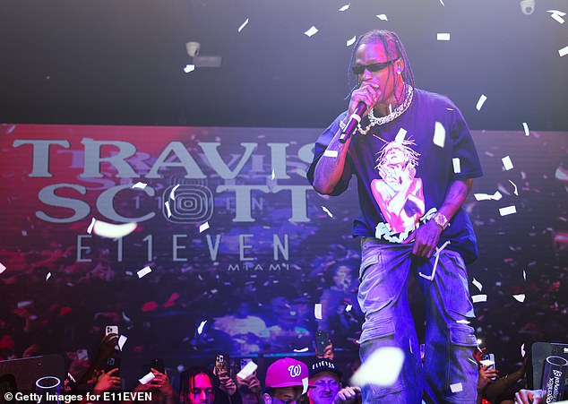 A couple was spotted getting cozy and cozy in a Las Vegas hotel room overlooking the Travis Scott concert on Saturday night;  Scott photographed performing at E11EVEN Miami last year