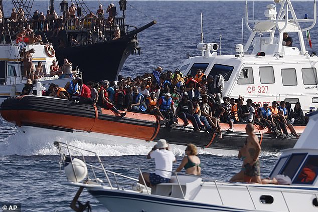Italy saw a 50 percent increase in illegal migrant landings last year compared to 2022, according to the Interior Ministry.  Pictured: Italian Coast Guard ship transports migrants near the port on the Sicilian island of Lampedusa, southern Italy, on September 18, 2023.
