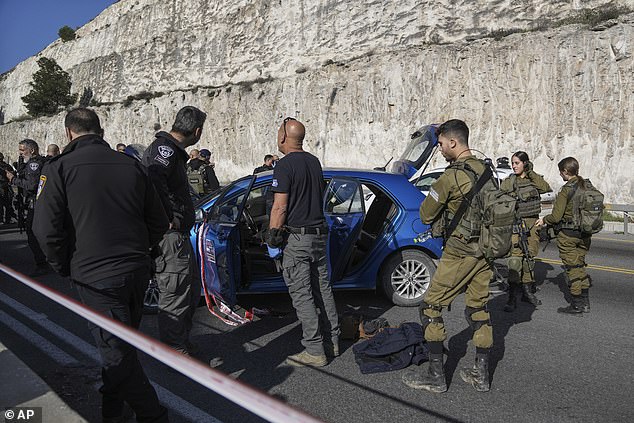 Israeli security forces examine the scene of a shooting attack near the Maale Adumim settlement in the West Bank, Thursday, February 22, 2024.
